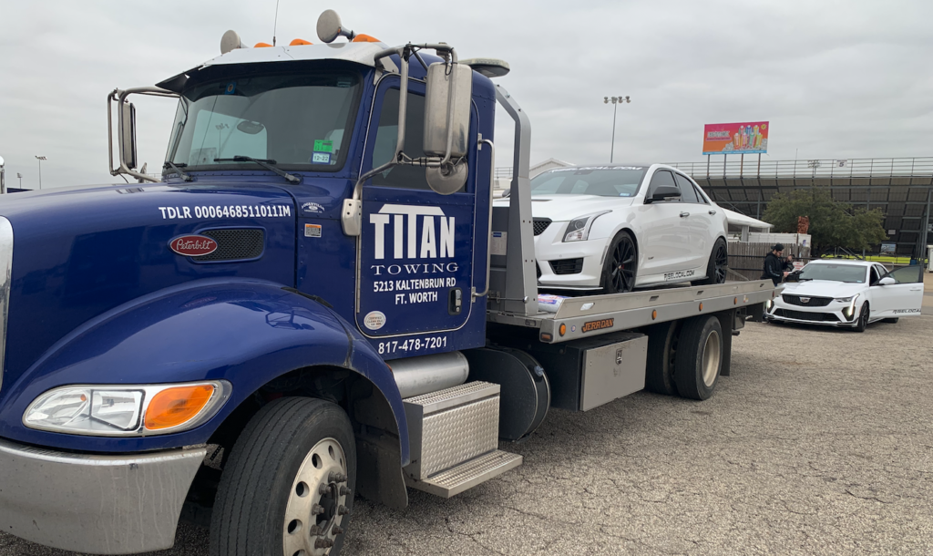 Titan Towing Tow Truck Towing a Cadillac from Texas Motor Speedway in Ennis.