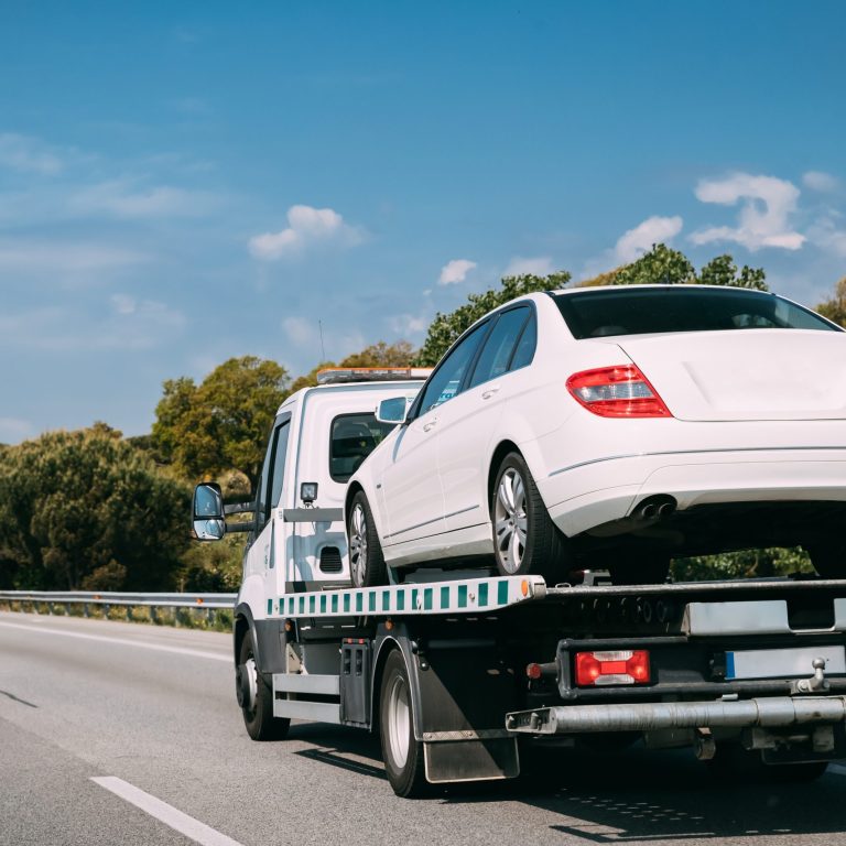 Car Service Transportation Concept. Tow Truck Transporting Car Or Help On Road Transports Wrecker Broken Car. Auto Towing, Tow Truck For Transportation Faults And Emergency Cars . Tow Truck Moving In Motorway Freeway Highway.